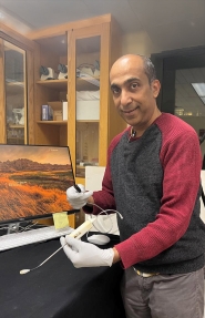Dr. Sunil Manjila holding the multiport MR-compatible neuroendoscope prototype